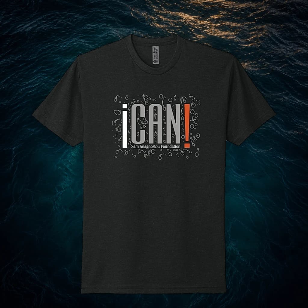 Black ICAN Tee with the Sam Anagnostou Foundation name, featured over dark ocean water